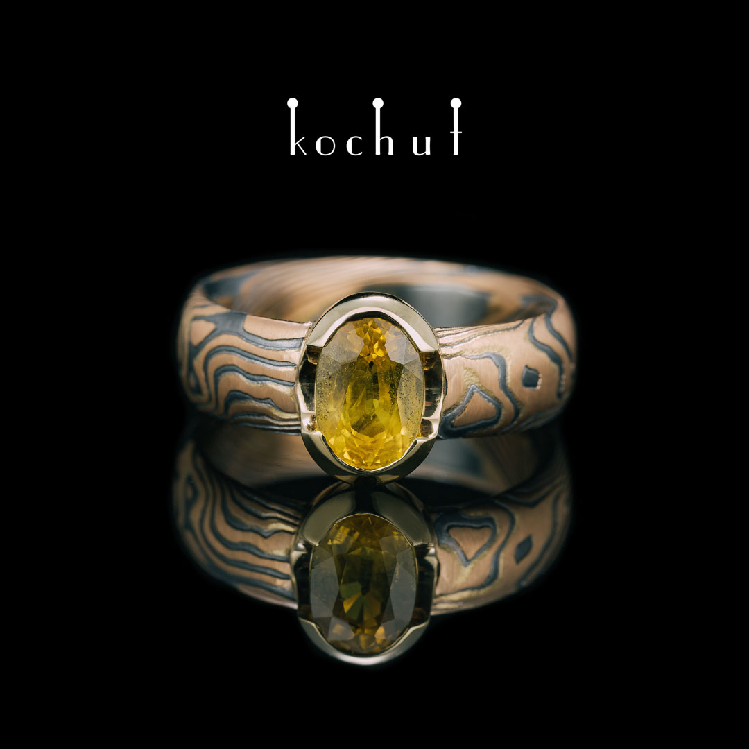 Ring mocume «Sophora». Red and yellow gold, etched silver, oxidized, yellow sapphire