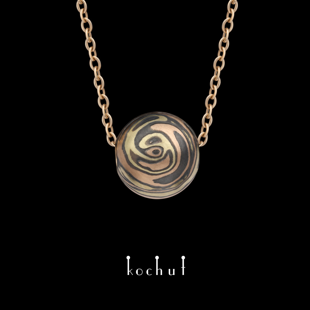 Mokume pendant «Whirlwind». Yellow, red gold, etched and oxidized silver